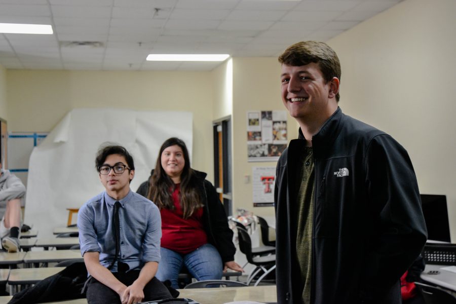 Juniors Sebastian Lemus and Reid McEowen and senior Jacky Orozco prepare for the weekly current events quiz.