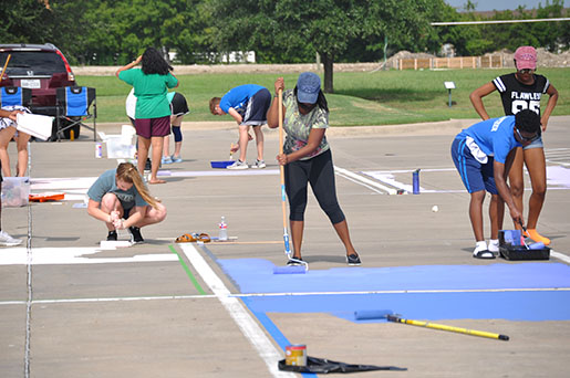 Students begin the early stages of painting.