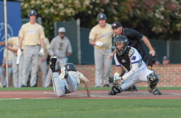 Senior Joey Erickson slides into home plate against Plano West.