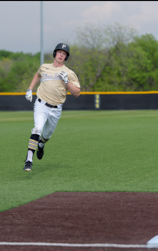 Junior Jonathan Mcnair rounds third base.