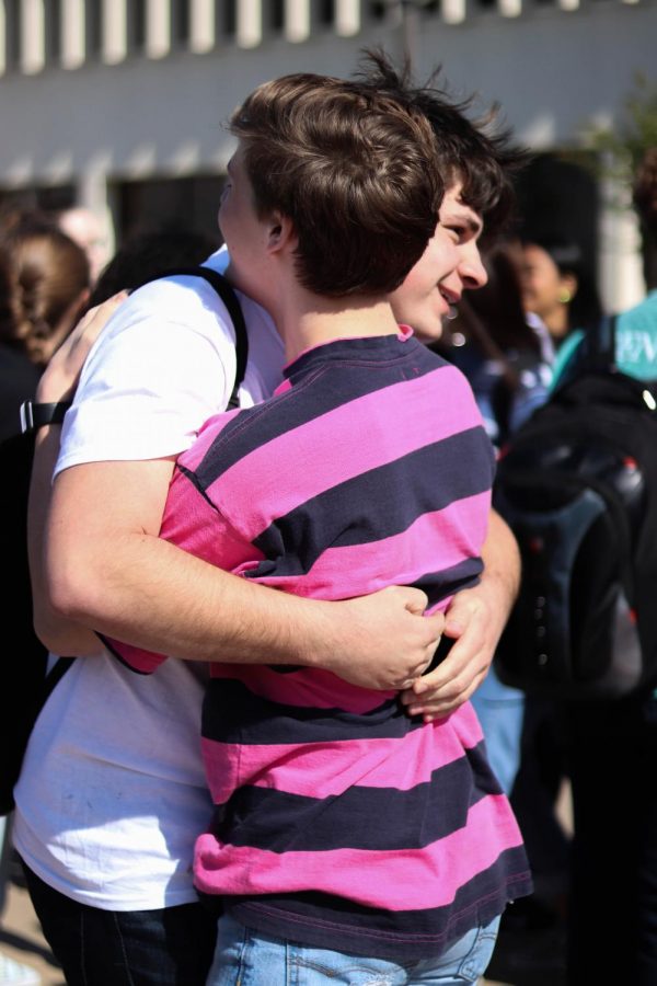 Senior Jacob Browning hugs a friend at the walk out for the Columbine High School Shooting.