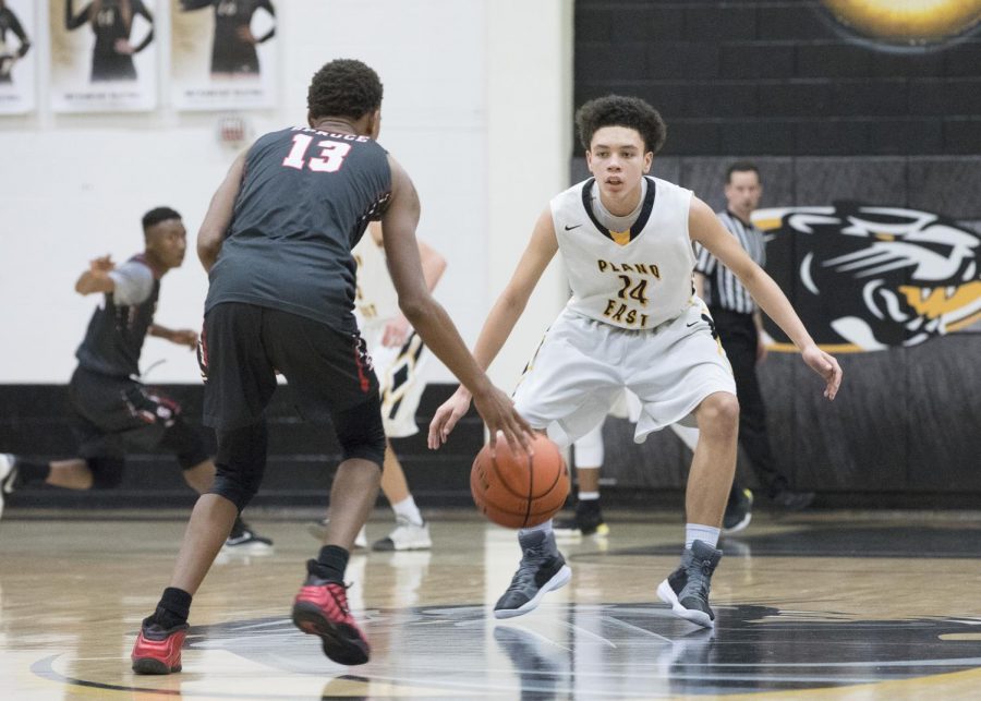 Freshman Connor Johnson defends  Spruce point guard at the top of the key on Feb. 8.