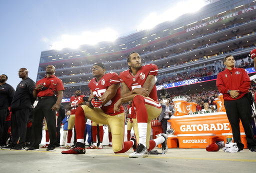 Quarterback Colin Kaepernick (7) and safety Eric Reid (25) kneel during the National Anthem prior to a game against the Los Angeles Rams on Sept. 12.
