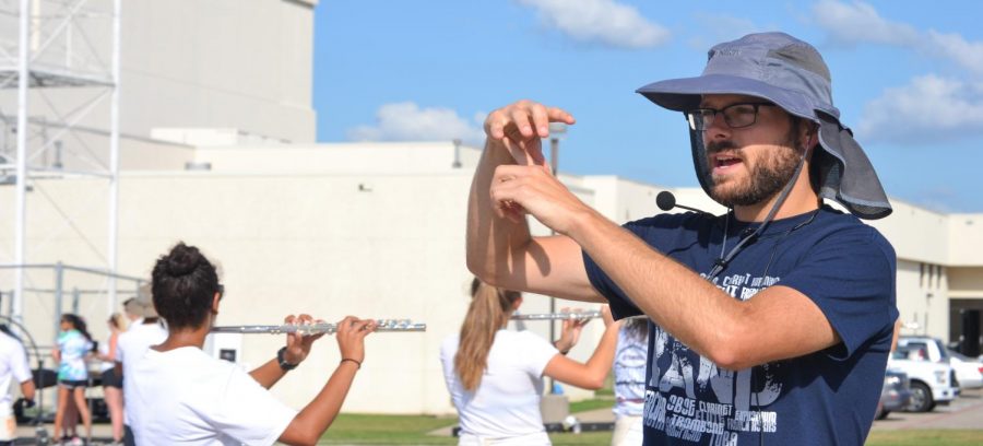 Mr. Albert directs the flutes during marching practice after school on Sept. 13.