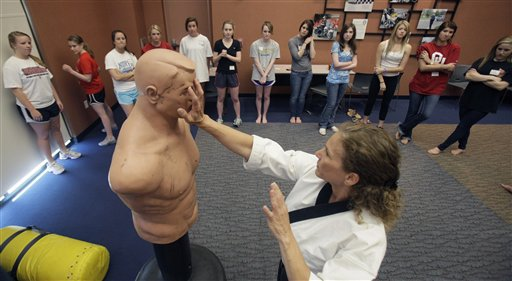 Marilyn Kirby shows young girls self-defense tactics on a dummy target in Plano, Texas on Mar. 26, 2011.