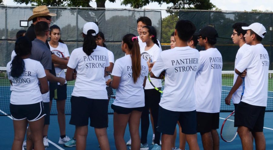 The JV tennis team holds a team meeting dring practice on Sept. 20.