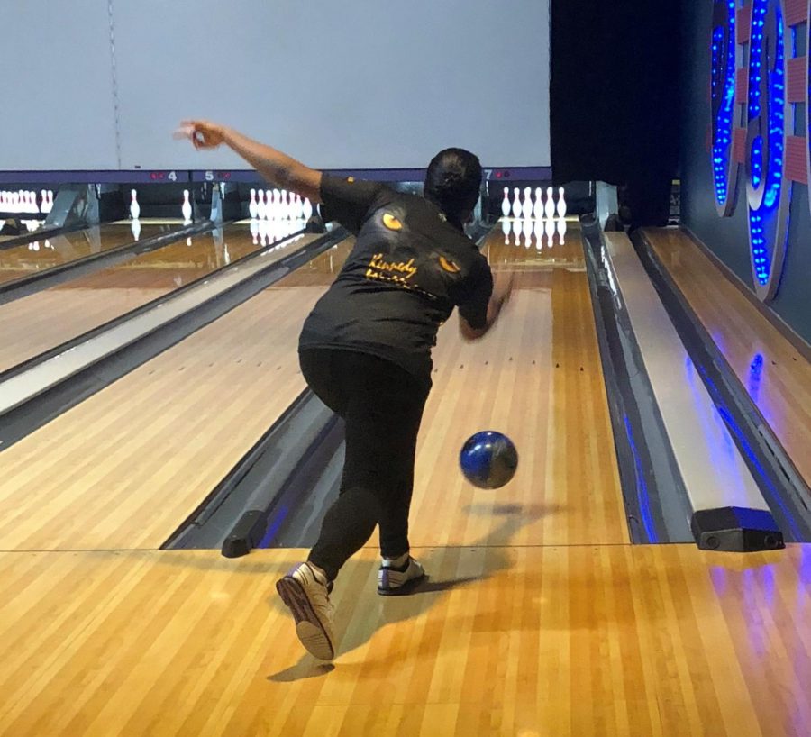 Senior and JV bowler Kennedy Williams launches a ball down the lane at Plano Super Bowl during the Panther Bowlers CARE project on Feb. 18.