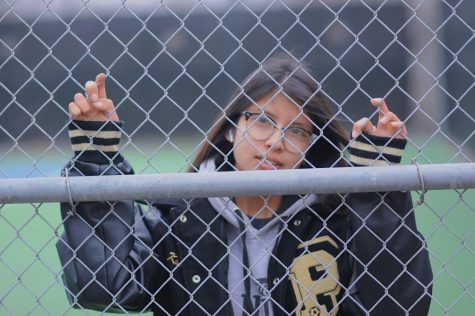 Senior Jennifer Chavira hides behind the fence leaving her eyes to tell the story.