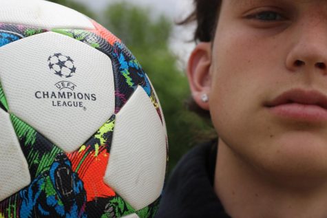 Junior and soccer player Dylan Mandala holds a soccer ball and shows off his earing on April 23.