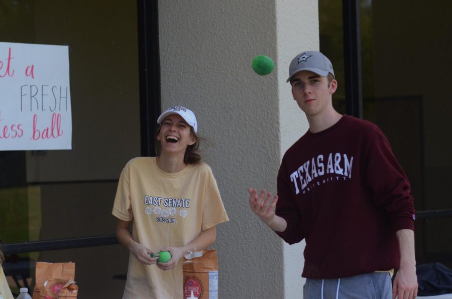 Silly senate seniors. Senate members senior Maddy Pupo and senior Austin King toss around DIY stress balls at their stand.