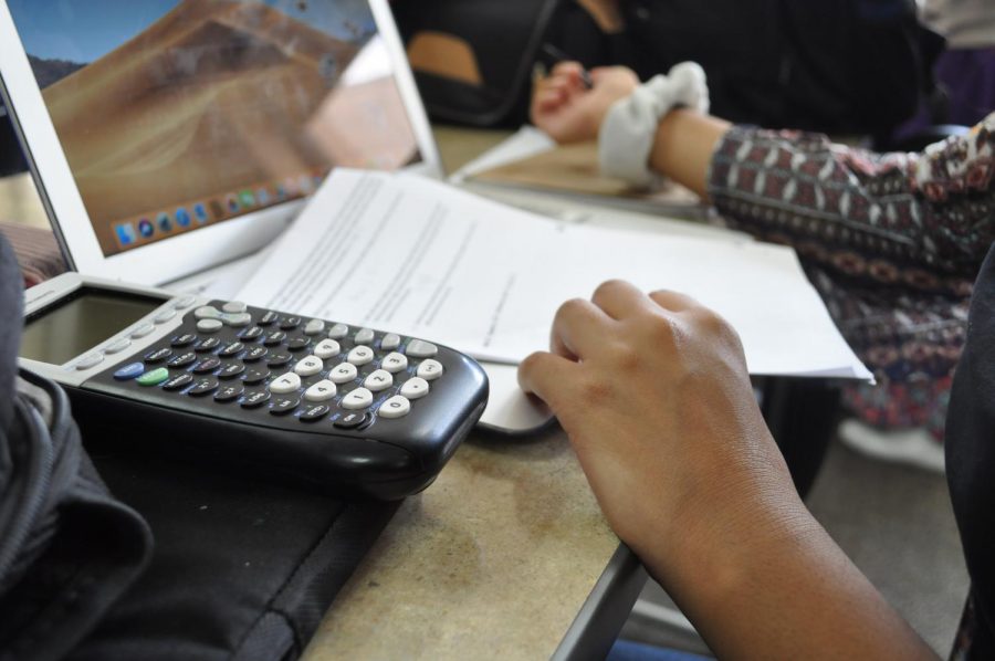 Balancing Act: Senior Fatima Malik works on several assignments at once. Students struggle with taking both high-level classes and electives and the new GPA system aims to fix the imbalance. I think [the new GPA policy] is a good and bad thing, senior Teena James said. But itll let kids have more time to find what they want to do.
