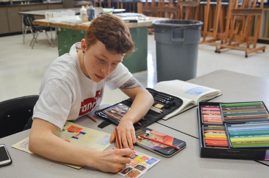 Junior+Max+Mosely+works+on+an+art+project+during+B+lunch+Oct.+10.+He+recreated+a+photo+of+individually+wrapped+candies+using+Prismacolor+colored+pencils.%0A