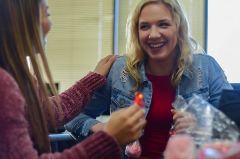 Seniors Mallory Migl and Marisa Romero eat candy during lunch. Migl and Romero both dressed in pink and red to compliment the festivities.  “I love being with my friends on Valentine’s Day,” Migl said. “Today we all ate together in class and shared treats.”