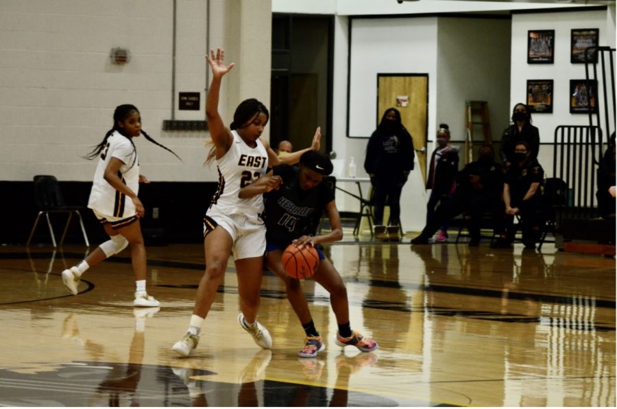 In the game versus Hebron, junior Donavia Hall plays defense while trying to block middle penetration from the other team.