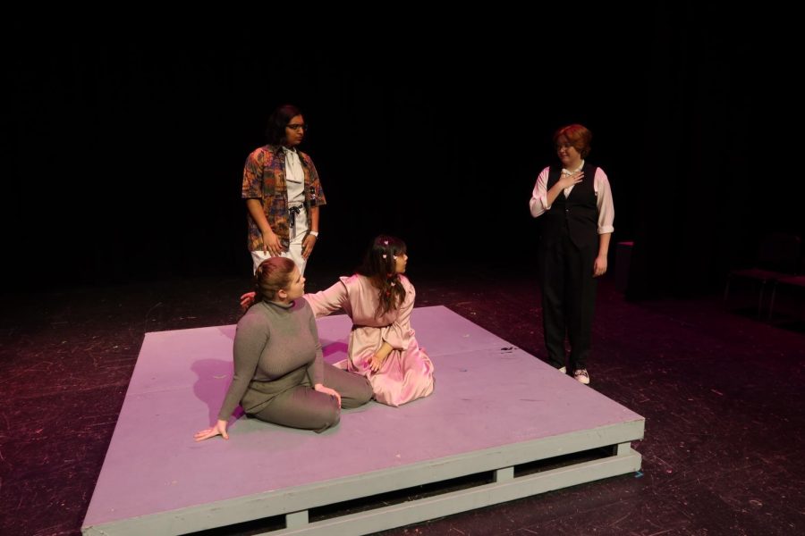 Actor Rebecca Smith playing Understanding, enters the scene to calm actors Harper Whittemore playing Everybody, Shruti Singh playing Love, and Sneha Kar playing Death.