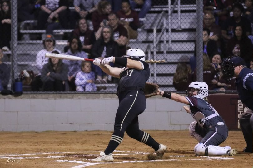 Senior Victoria Jackson-Sears hits the ball during a softball game. 