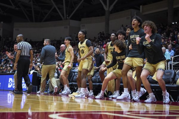 The team cheers after a player scored at the game against Allen on February 27 at the Curtis Culdwell Center in Garland.
